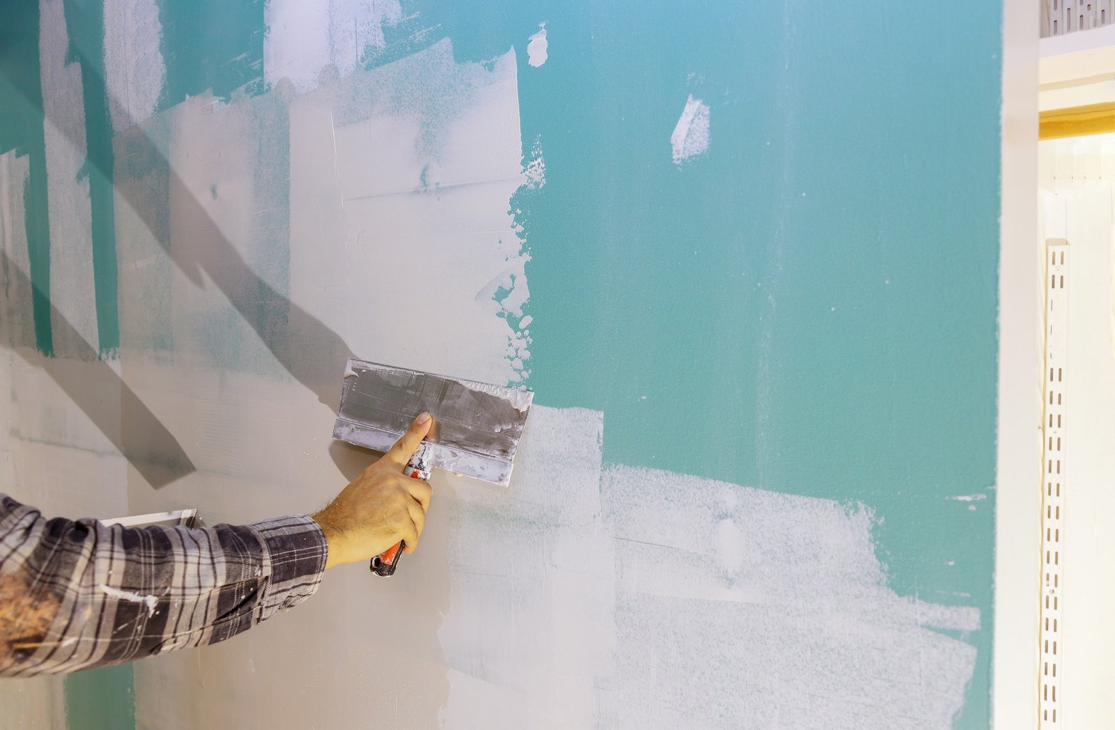 Worker work aligns with a spatula wall